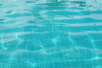 Background of rippled pattern of clean water in swimming pool 