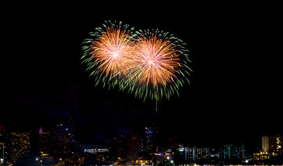 Happy new year fireworks over cityscape at night.holiday celebration festival