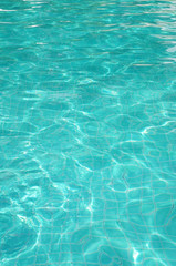 Fototapeta na wymiar Background of rippled pattern of clean water in swimming pool 