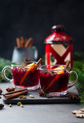 Mulled red wine with spices. Christmas decoration. Grey background. Copy space.