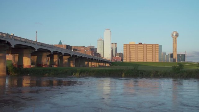 4K-Dallas Skyline with the Trinity River in the foreground during Golden Hour.  - Slow Moving Water