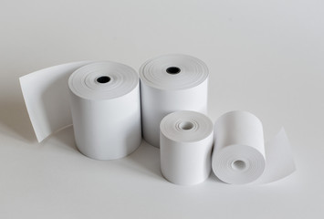 Roll of cash register tape isolated on soft gray background.