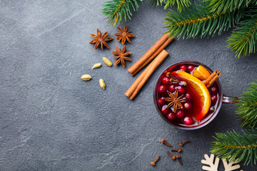 Mulled red wine with spices. Christmas decoration. Grey background. Copy space. Top view.