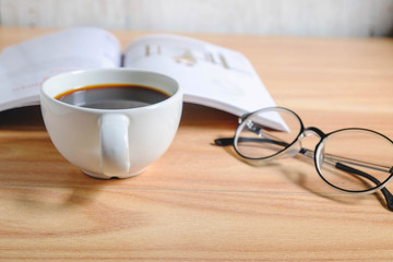 Coffee cup and book with glasses