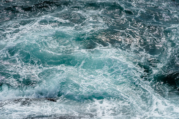 Fototapeta na wymiar Motion of sea water surface with stone, Blue water splashing