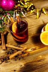 Christmas mulled wine with spices and Christmas decoration on wooden table