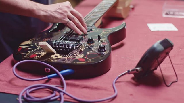 Guitarist tuning electric guitar