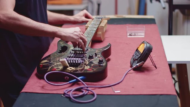 Tuning guitar with electric tuner