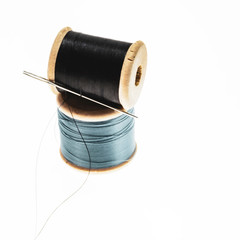 wooden spools of thread and needle