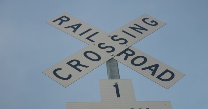 Railroad crossing warning sign on a pole