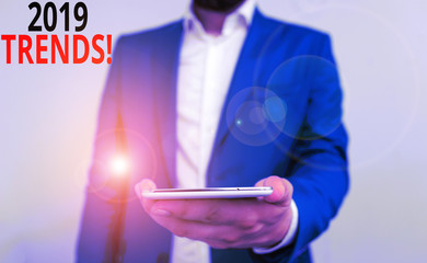Word writing text 2019 Trends. Business photo showcasing general direction in which something is developing or changing Business concept with man holding mobile phone with touch screen