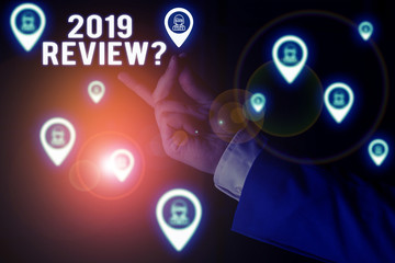 Text sign showing 2019 Review Question. Business photo showcasing remembering past year events main actions or good shows Male human wear formal work suit presenting presentation using smart device
