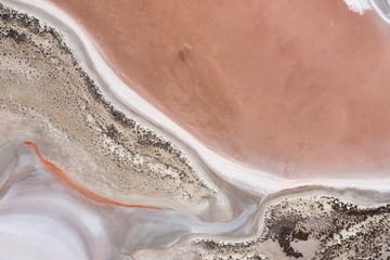 Abstract top down view of a large pink salt lake located next to highway 40 in the wheatbelt region of Western Australia