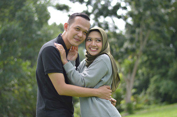 lovely asian Muslim young couple embracing at outdoors