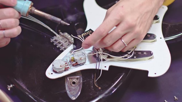 Repairing the interior electrical parts of a guitar