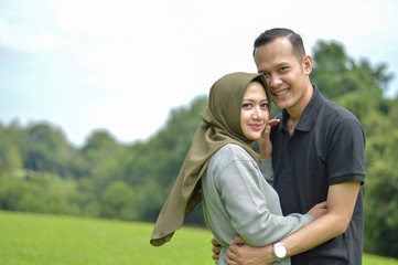 lovely asian Muslim young couple embracing at outdoors
