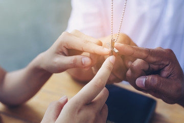 people christian team holding hands and touch finger to cross symbol