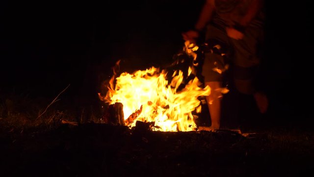 People Jumping Over Campfire At Night, 4K, 60fps