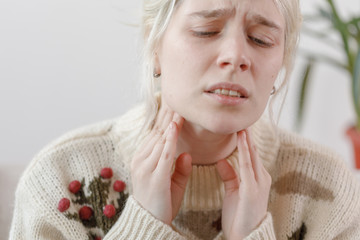 The girl in the sweater is sick. Colds and flu. The patient caught a cold, feeling sick. Unhealthy...