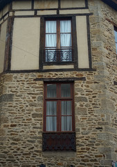 Old traditional French stone building with wooden windows