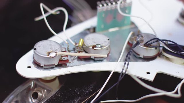 close up of soldering a guitar pickguard