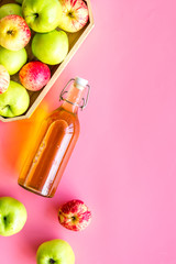 Vinegar made from fresh apple on pink background top view space for text