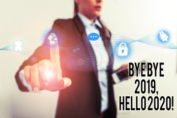 Text sign showing Bye Bye 2019 Hello 2020. Business photo text saying goodbye to last year and welcoming another good one Female human wear formal work suit presenting presentation use smart device