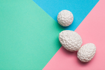 Easter eggs with geometric patterns on color blocks background with copy space