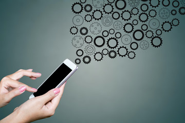 hand holding smart phone setting concept with cogwheel background     