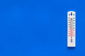 Weather thermometer on blue background top view copy space