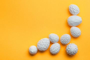 White Easter eggs with geometric patterns on yellow background