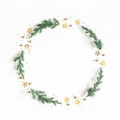 Christmas composition. Wreath made of fir tree branches, golden decorations on white background. Christmas, winter, new year concept. Flat lay, top view, copy space