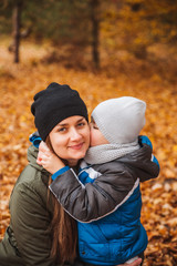 portrait of mother with kid son together in autumn outfit