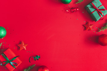 Christmas composition. Gift box, christmas decorations on red background. Flat lay, top view, copy space - 296013696