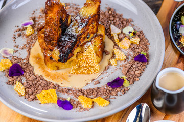 Pan fried Pain Au Chocolate pudding with Chai Custard and Sesame Snaps