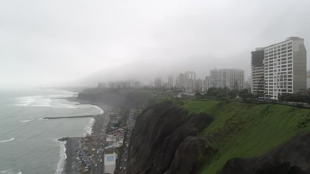 Forward drone view of the pier in Miraflores, Lima Peru at a winter cloudy day.