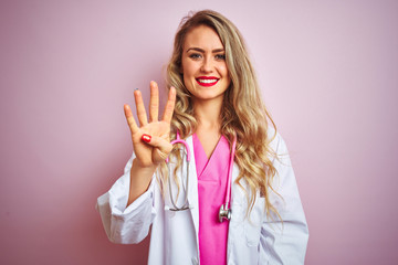 Young beautiful doctor woman using stethoscope over pink isolated background showing and pointing up with fingers number four while smiling confident and happy.