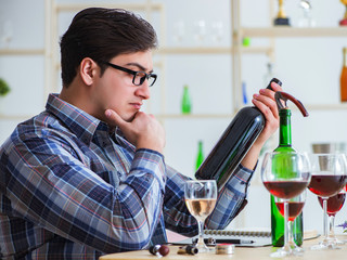 Professional sommelier tasting red wine