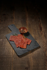 Luxurious image of jerky and pepper on vintage table.