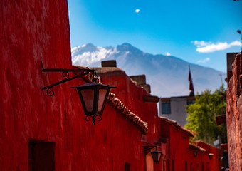 Views of the Misti volcano from the narrow streets with red walls of the  Saint Catherine Monastery (Convento de Santa Catalina), Arequipa city, Peru
