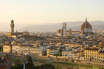 Florence city during golden sunset. Panoramic view of the river Arno with Palazzo Vecchio palace and Cathedral of Santa Maria del Fiore (Duomo), Florence, Italy.