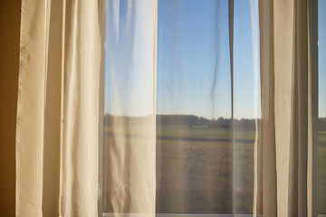 Transparent white curtain on window and nature behind it. Curtain background