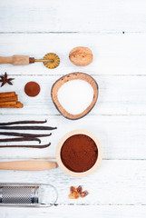 dessert ingredients and kitchen utensils on old white wooden table