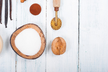 dessert ingredients and kitchen utensils on old white wooden table