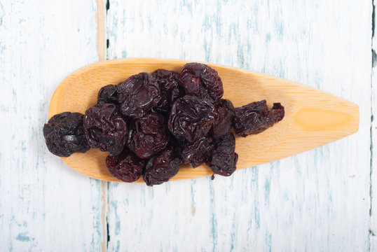 dried cherry fruits on white wooden