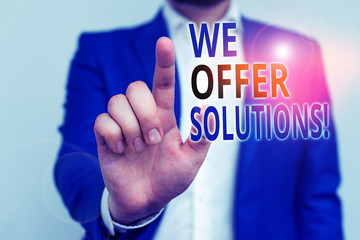 Word writing text We Offer Solutions. Business photo showcasing way to solve problem or deal with difficult situation Businessman in blue suite and white shirt pointing with finger in empty space