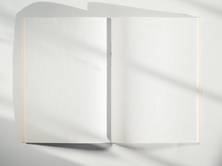 A white sketch book on a white background with shadows