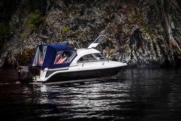 A small pleasure boat with a motor for excursions and relaxation in picturesque places on the water...