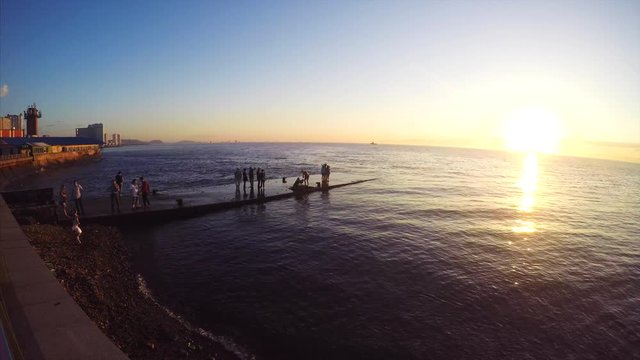 Timelapse of Vladivostok quay and many people coming on pier to take pictures and enjoy of sunset above the sea. Russia
