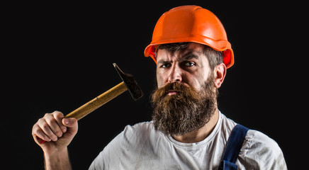Hammer hammering. Builder in helmet, hammer, handyman, builders in hardhat. Bearded builder...
